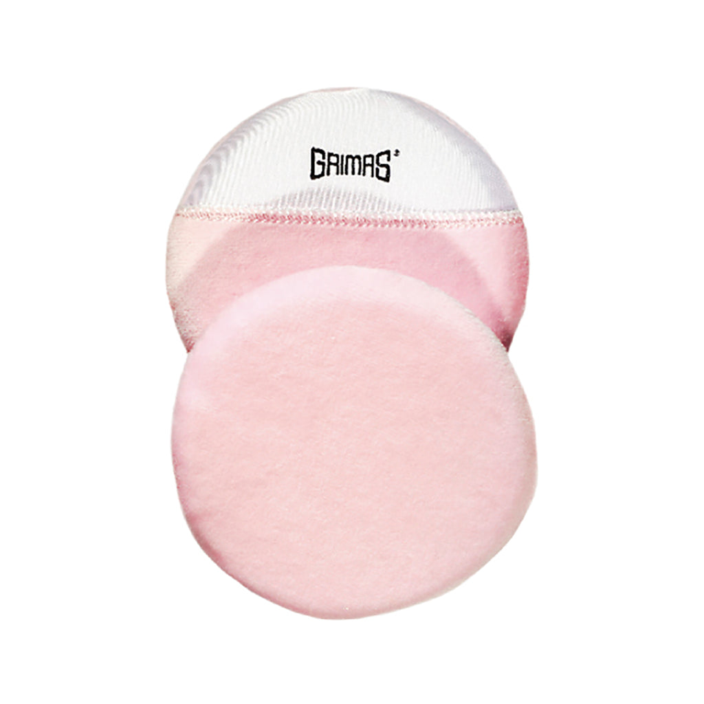 Grimas to lyserøde pudderkvaste oven på hinanden